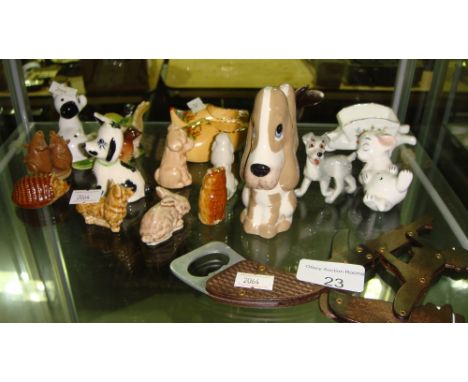 Shelf of decorative ornaments including Seizler dogs and Wade whimsies