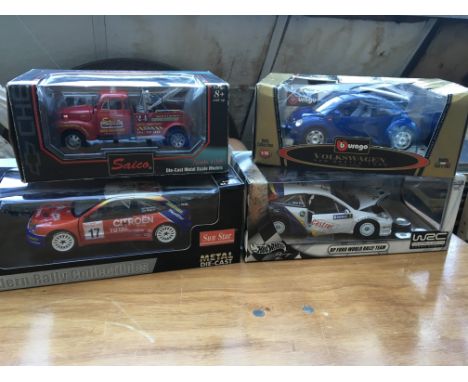 A collection of boxed diecast 1:18 scale vehicles including Sun Star , Saico, Burago and Hot wheels