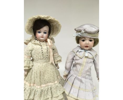 Two bisque head dolls in Edwardian style dress 38 cm .