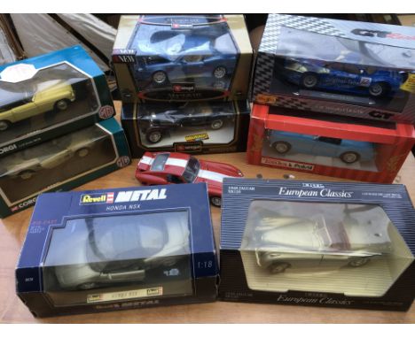 A collection of boxed diecast vehicles including 1:18 scale models by Corgi, Revell, ERTL, Maisto, Burago etc