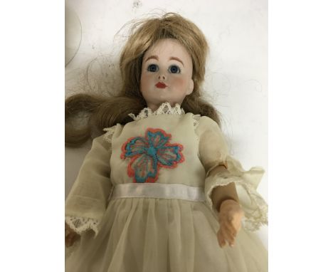 A bisque head doll on stand Simon Halbig on stand 28 cm .