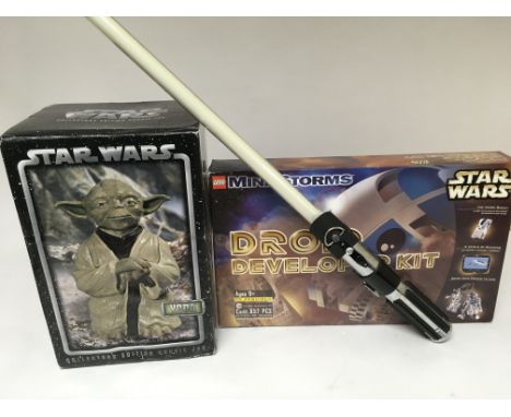 A Star Wars Yoda cookie jar,Droid developer kit and a Light sabre.(3)