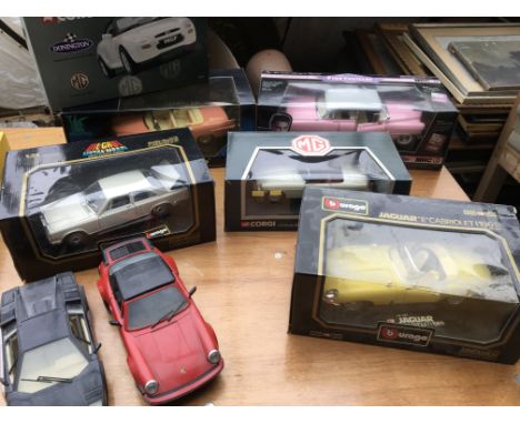 A collection of boxed 1:18 scale diecast vehicles including Corgi, Burago etc