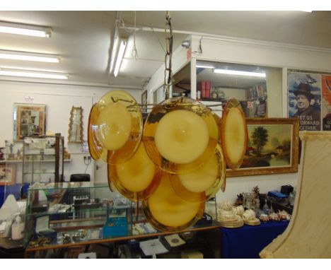 A retro Italian designer ceiling light, glass disc designed in Amber