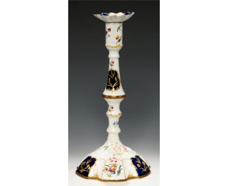 A   SOUTH STAFFORDSHIRE ENAMEL CANDLESTICK, C1770 painted with loose bouquets, scattered flowers and dark blue reserves of ra