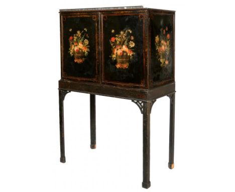 A NORTHERN EUROPEAN BLACK JAPANNED CABINET ON STAND, FIRST HALF 19TH C  the doors and sides painted with baskets of flowers, 