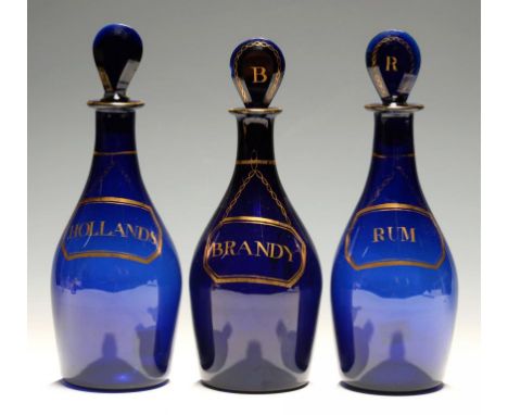 THREE ENGLISH BLUE GLASS DECANTERS AND STOPPERS,  LATE 19TH C  labelled in gilt  BRANDY, HOLLANDS or RUM, 23cm h, polished po