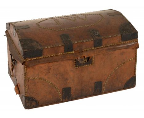 A NORTHERN EUROPEAN  BRASS NAILED TAN LEATHER TRAVELLING TRUNK, EARLY 19TH C  the coffered lid with the initials IW, black pa