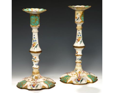 A PAIR OF   SOUTH STAFFORDSHIRE ENAMEL CANDLESTICKS, C1770 painted with loose bouquets and apple green reserves, nozzles, 25c