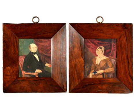 ENGLISH NAIVE ARTIST, EARLY 19TH C   PORTRAIT OF A LADY; A GENTLEMAN  pendants, seated half length before red drapery, waterc