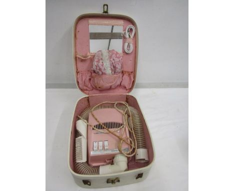 A vintage pink boxed elec hairdrier. for display purposes