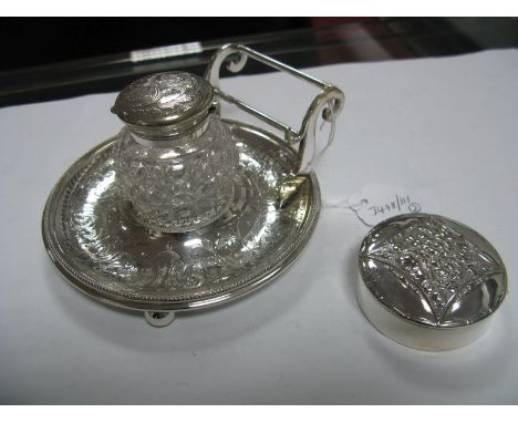 A Decorative Mounted Glass Inkwell, fitted on circular stand with pen rest, overall on four ball feet; together with a circul