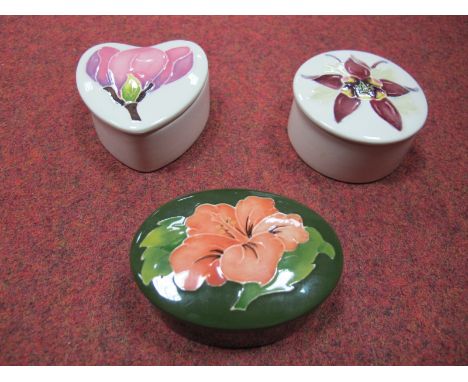 Three Modern Moorcroft Trinket Jars and Covers, including Magnolia, Columbine and Hibiscus, varying forms. (3)