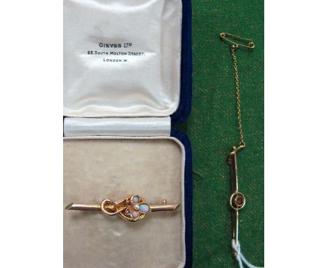 An Opal Set Bar Brooch, stamped "15ct", in a fitted case; together with another bar brooch circular collet set to the centre.