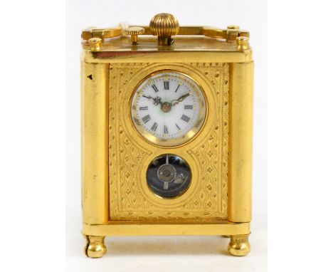 An early 20th century gilt metal cased brevet eight day miniature carriage clock with circular white enamel dial set with Rom