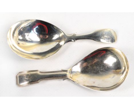 Two George III hallmarked silver fiddle pattern caddy spoons, one with engraved initial "C" to finial, the other engraved wit