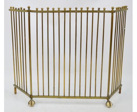 An unusual Victorian brass fireguard of small proportions, with twin hinged side frames, etched decoration and raised on ball