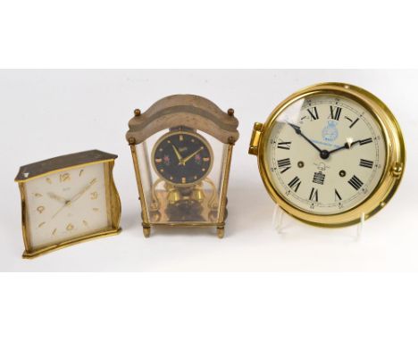 A brass mounted ships clock, the circular enamel dial set with Roman numerals, inscribed "Battle of The Atlantic 50th Anniver