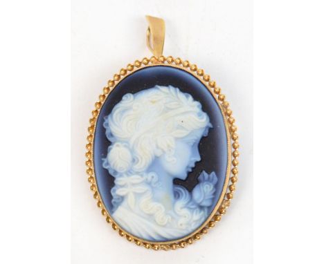A blue agate cameo brooch/pendant, the oval plaque carved with the profile portrait of a young woman within a 9ct gold frame 