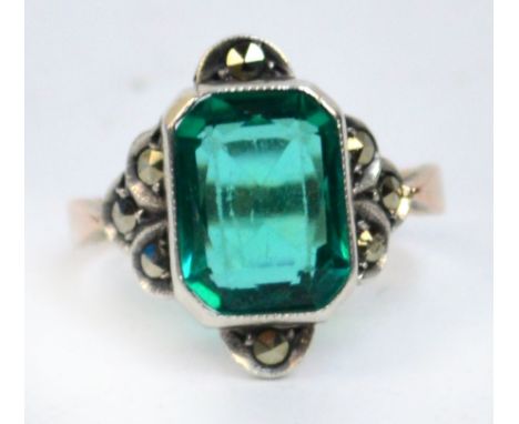 A 9ct gold dress ring centred with a large green stone, size K 1/2.