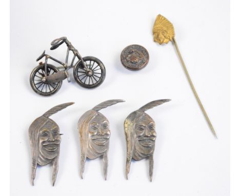 Cycling interest; a white metal brooch modelled as a bicycle, three brooches modelled as Native Americans inscribed "Indian M
