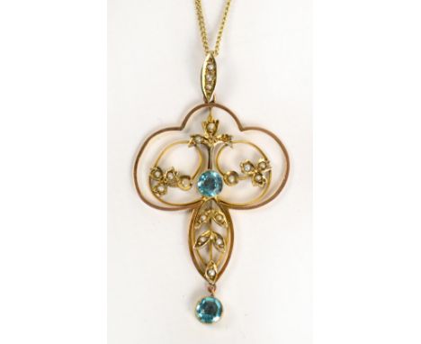 An Art Nouveau 9ct gold floral pendant set with two light blue coloured stones and seed pearls, length 4.5cm, suspended by a 