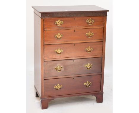 A 19th century mahogany chest of five graduated drawers with blind fret carved frieze on bracket feet, 108 x 77 x 44cm. CONDI