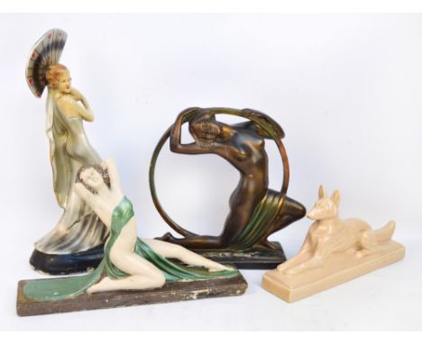 Three Art Deco style painted plaster figures, heights 53cm, 38cm and 30cm, also a French glazed pottery model of an Alsatian,