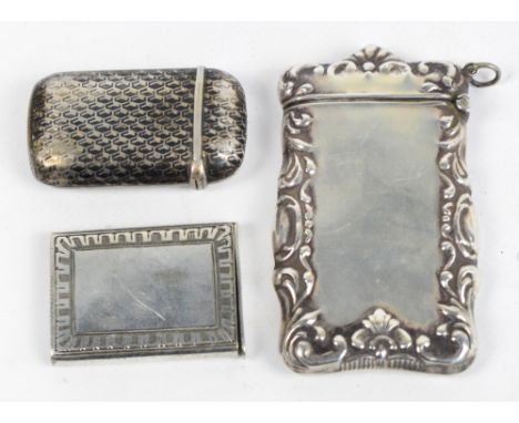 A 925 grade silver vesta case of rounded rectangular form with scroll decorated border, a Niello rounded rectangular small ve