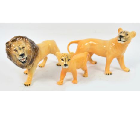 A Beswick trio of lion, lioness and cub. CONDITION REPORT: Appears good with no obvious signs of faults, damage or restoratio