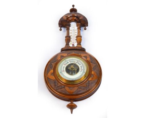 An early 20th century carved walnut wall barometer/thermometer, height 45cm.