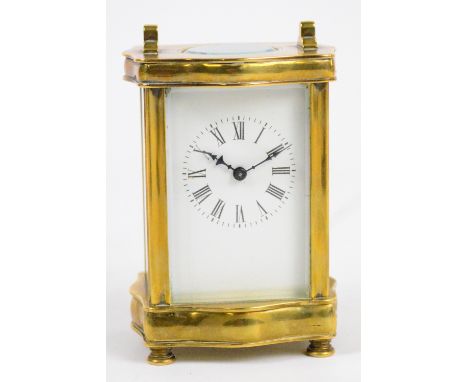 An early 20th century French carriage clock, with shaped brass case and square white enamel dial set with Roman numerals, hei