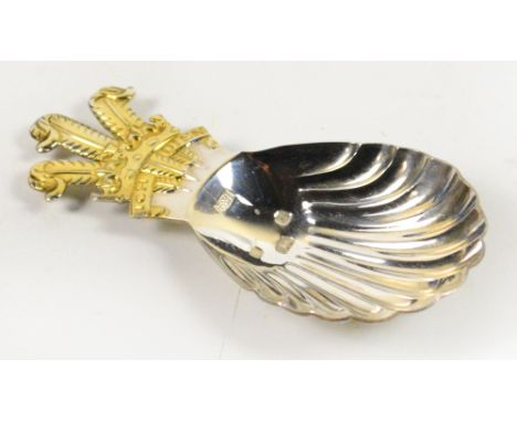 A cased Elizabeth II hallmarked silver scallop shaped caddy spoon with gilt Prince of Wales feather to the terminal, Roberts 