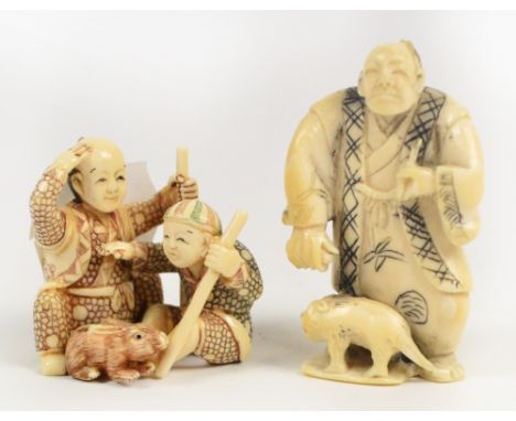 Two decorative 20th century Japanese bone netsukes, one depicting a man and an animal, the other depicting two boys playing w