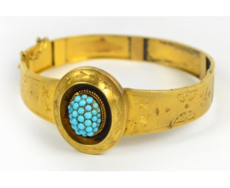 A Victorian yellow metal snap bangle with engraved decoration and central cluster of turquoise. CONDITION REPORT: The frame o