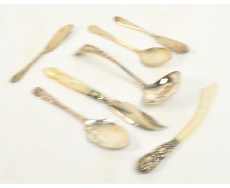 An Edwardian hallmarked silver sugar sifting spoon with embossed decoration to the bowl and engraved decoration to the handle