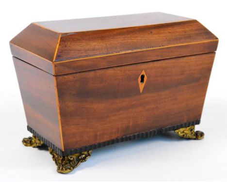 A 19th century mahogany veneered tea caddy of sarcophagus form with satinwood inlaid escutcheon and edges, with four brass sc