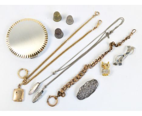 Two yellow metal chains; one supporting a rounded rectangular pendant, three decorative brooches, a scarf clip and chain, thr