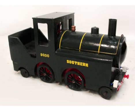 A wood and metal child's sit in push along train engine "Southern 9200", in green livery with yellow stripes, length 88cm.