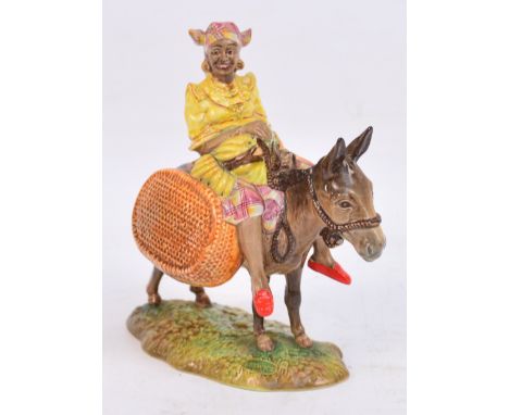 A Beswick figure; "Susie Jamaica", a lady seated on a donkey, impressed to base "1347", height 18cm. CONDITION REPORT: Surfac