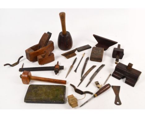 A small collection of woodworking tools including two planes, mallet, etc.