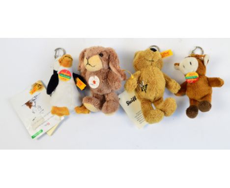 Four modern Steiff keyrings; teddy bear, rabbit, cow, and penguin.