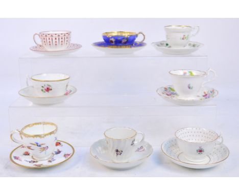 Eight early 19th century hand painted porcelain cups and saucers, one decorated with birds and floral sprays, all unmarked.