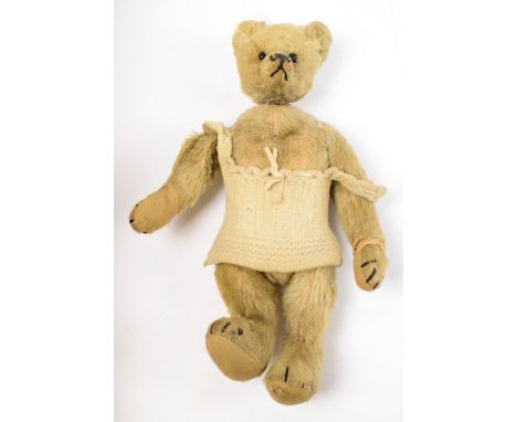 A c.1905 Steiff bear with glass eyes, articulated limbs with vertical stitched claws, wearing later knitted top, height 15cm 