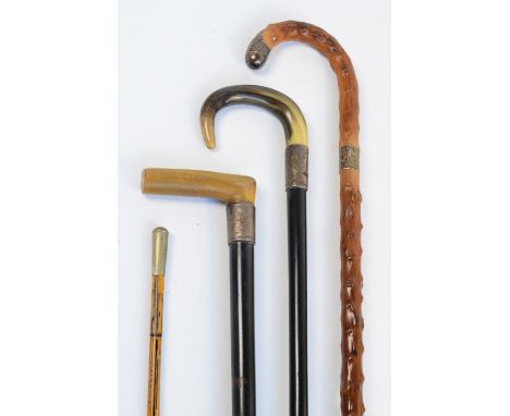 Two horn handled ebonised walking sticks with hallmarked silver mounts, one engraved "Presented by Board of Management and St