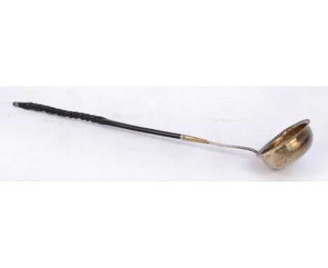 A George III hallmarked silver toddy ladle with oval bowl and wrythen twisted baleen handle, indistinct marks to the bowl, le