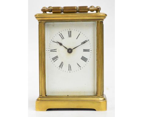 An early 20th century French brass cased carriage clock, the rectangular white enamel dial set with Roman numerals, with swin
