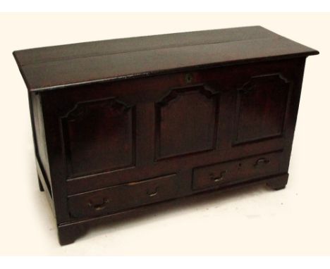 An early 18th century oak blanket box, the hinged lid above fielded panels and two drawers raised on bracket feet, width 144.