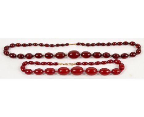 Two late 19th/early 20th century cherry amber coloured graduated bead necklaces, largest length 3cm, smallest length 1cm, tot