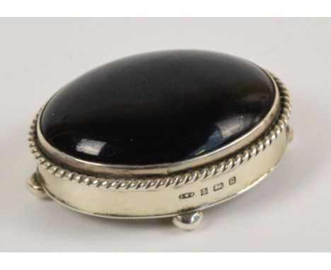 An Elizabeth II hallmarked silver oval trinket box on four bun feet, the hardstone set cover with brooch attachment, Birmingh